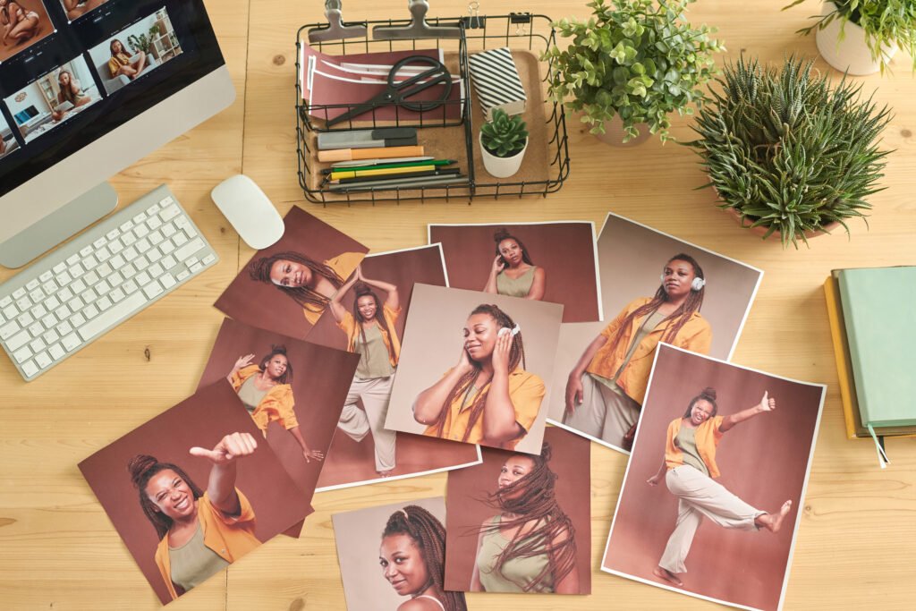 High angle view of workplace of photo editor with professional retouched images on it